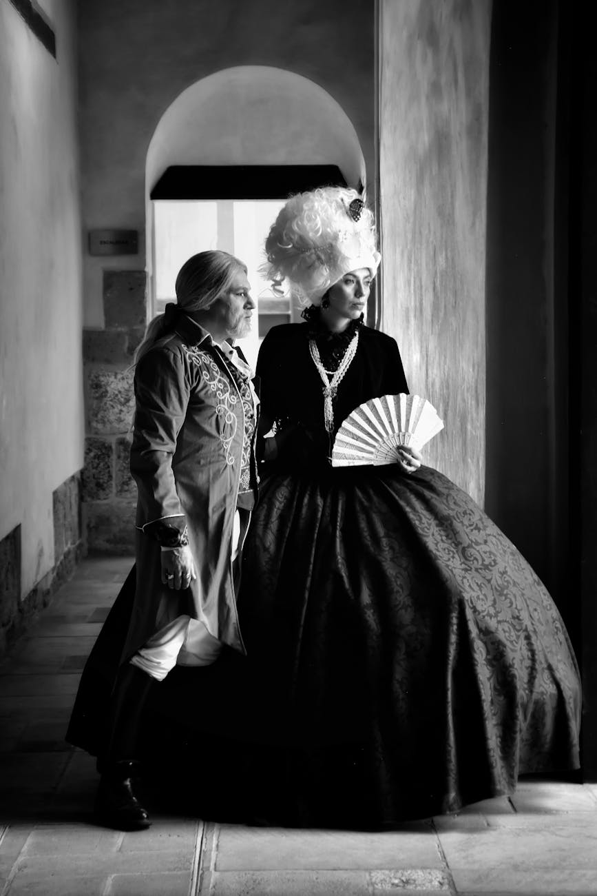 couple standing in baroque costumes